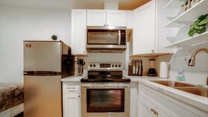 A kitchen with white cabinets, a stainless steel refrigerator, a microwave, an oven, and a sink. - Nurse-ready Rental 10 Mi to Dtwn Riverside! (Moreno Valley)