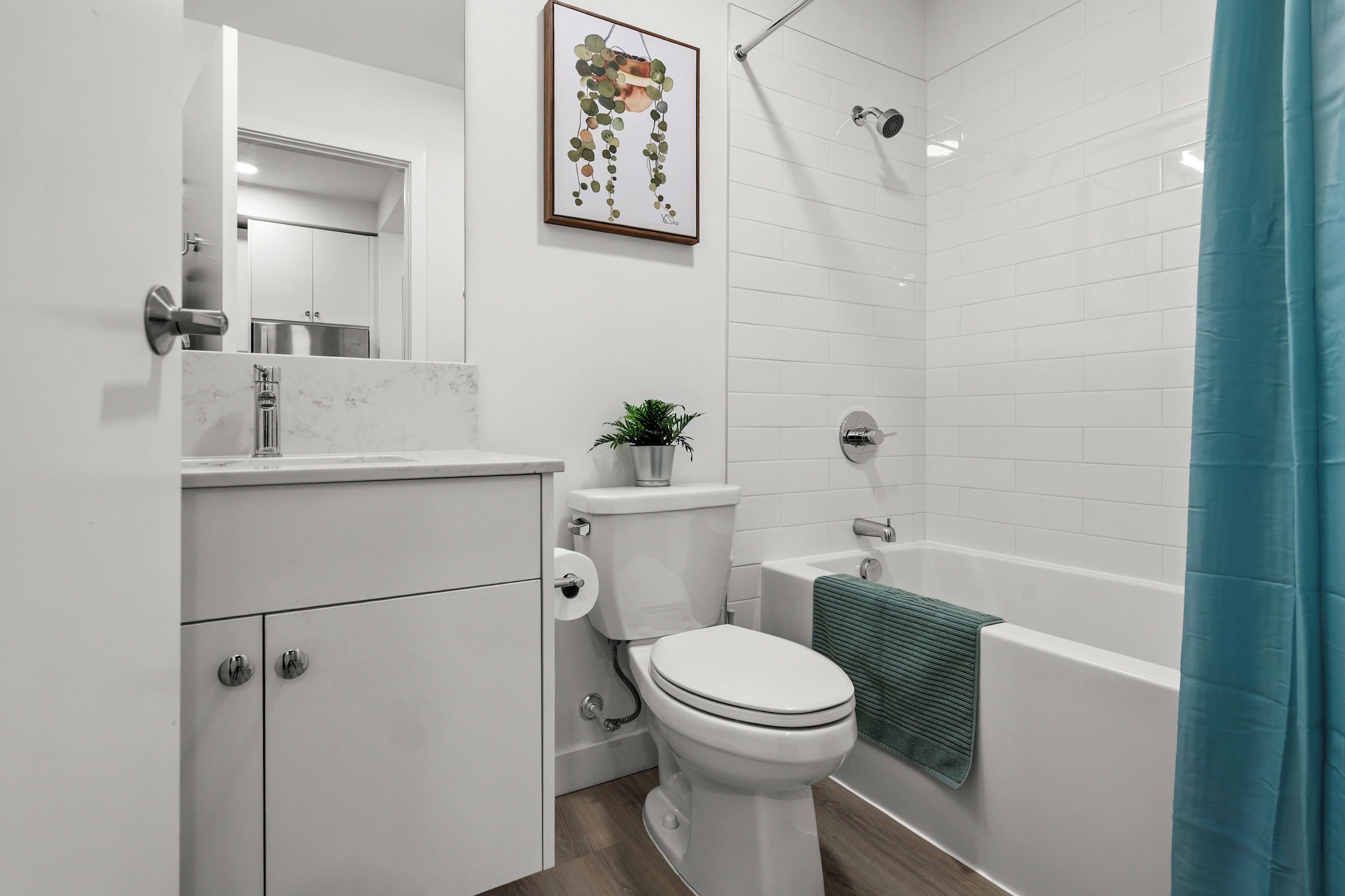 A modern bathroom with a toilet, sink, and bathtub.