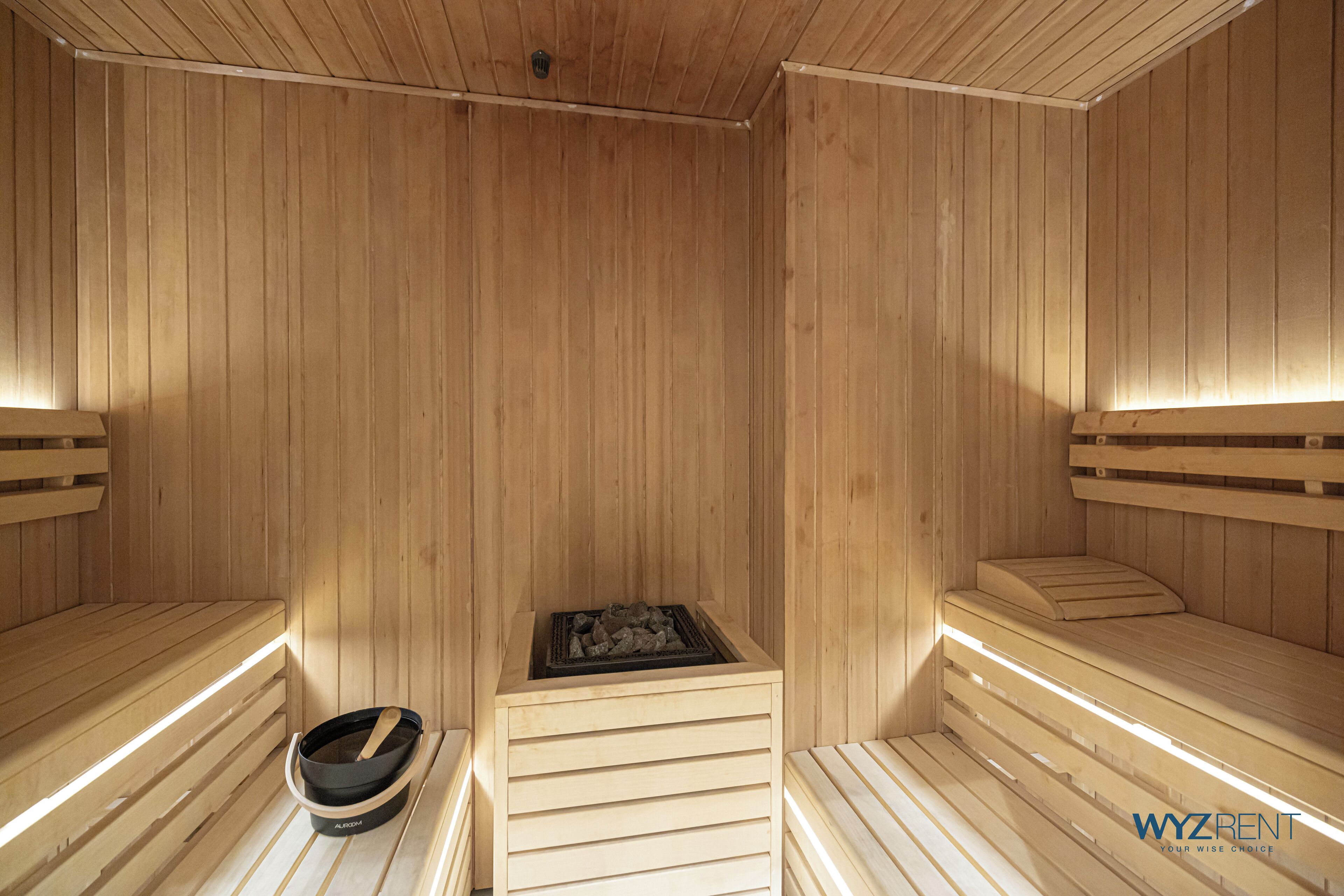 Un sauna avec des bancs en bois et un système de chauffage central.