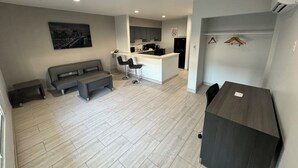 A modern apartment with a living area, kitchen, and dining space. - Englewood Inn & Suites (Englewood)