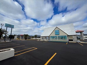 A parking lot with a building labeled "Englewood Inn & Suites". - Englewood Inn & Suites (Englewood)