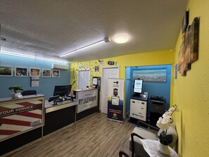 A reception area with a desk, computer, and a sign for 'Welcome to ENGLEWOOD'. - Englewood Inn & Suites (Englewood)