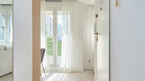 A modern hotel room with a large mirror, a wooden floor, a sliding door, and a view of the outdoors. - Point of Life 1 by Litto (Split)