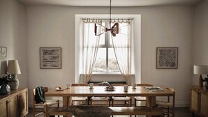 A dining area with a wooden table, chairs, a bench, and a chandelier. - Whole Coastal Estate · Sleeps 12 · Anglesey (Isle of Anglesey)