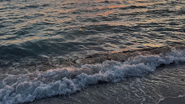 A sunset over the ocean with waves crashing onto the shore. - Modern Coastal Villa • Private Fenced Yard • Minutes to the Beach (Naples)