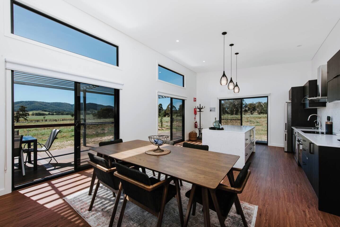 Frantoio Cottage's open-plan kitchen and dining area opens to the patio, creating a lovely transition between indoors and out.