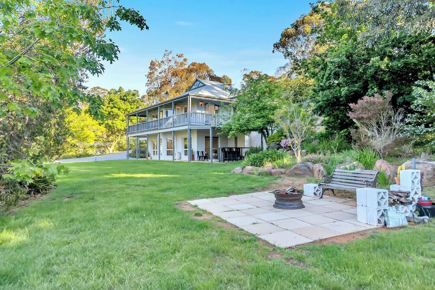 Sprawling lawns and a dedicated firepit create a versatile outdoor space for daytime play or starlit gatherings.