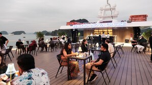 A restaurant with outdoor seating overlooking a body of water, named 'HALORA NOVA CRUISE'. - Halora Nova Cruise (Tuan Chau)
