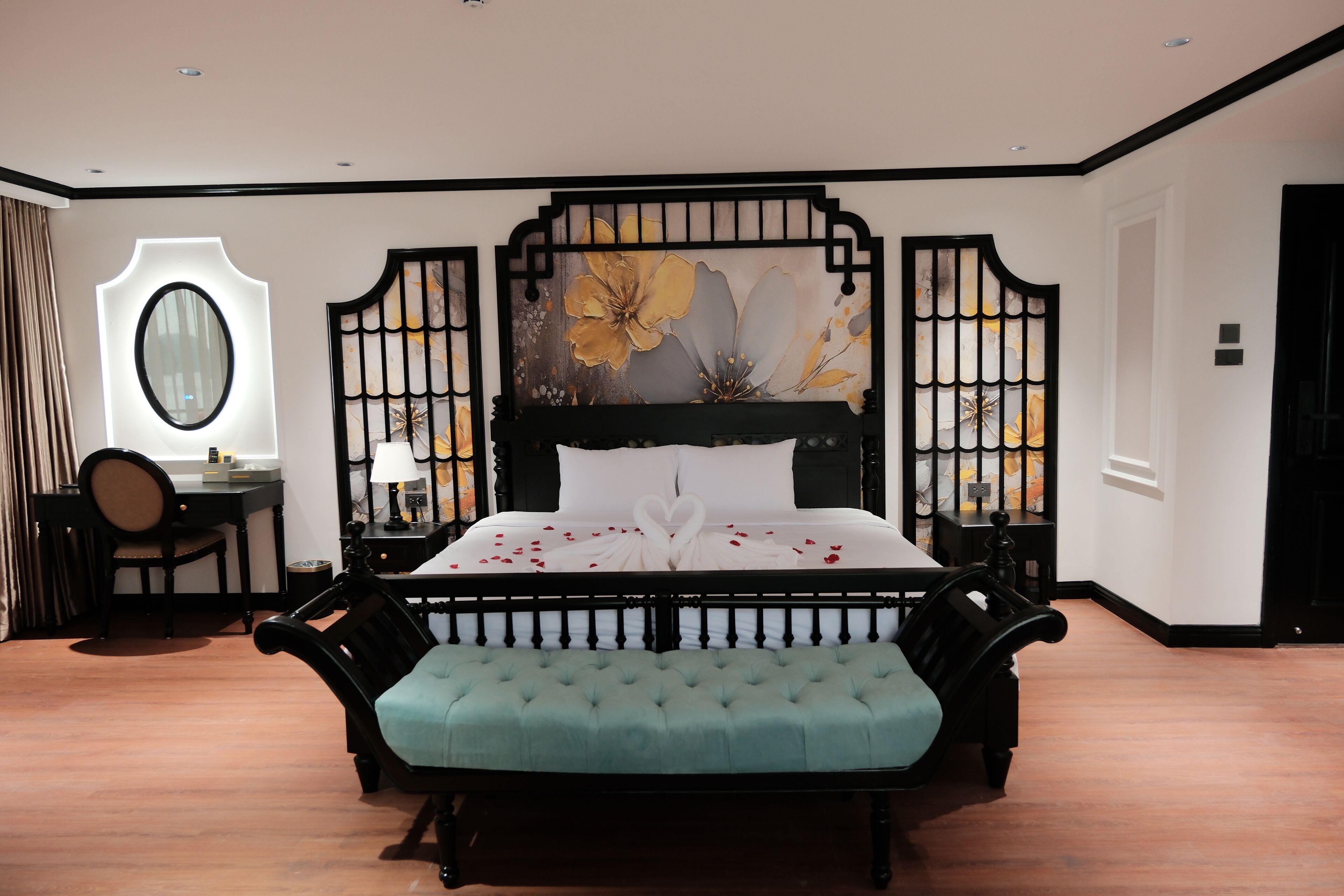 A bedroom with a bed, a desk, a chair, and a decorative wall piece.