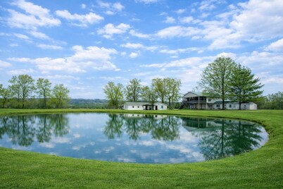 Relax at this peaceful two home countryside retreat with a private hot tub, pond views, 2 fire pits, and fishing for cozy comfort and country charm for everyone.