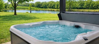 Relax at this peaceful two home countryside retreat with a private hot tub, pond views, 2 fire pits, and fishing for cozy comfort and country charm for everyone.