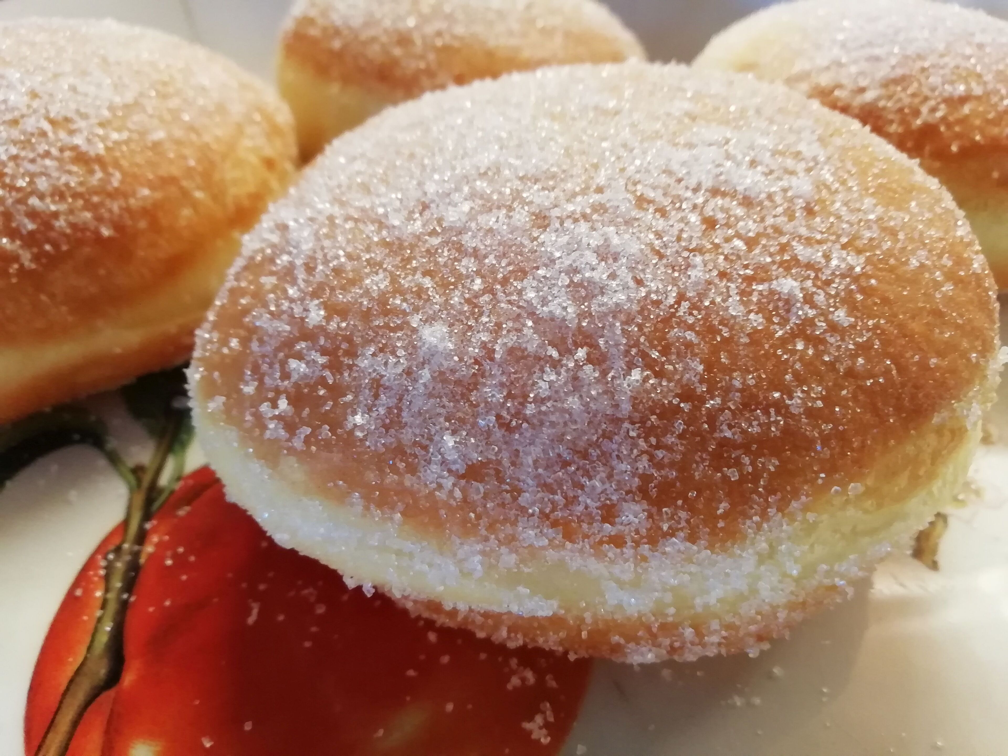 A close-up of a food item, possibly a pastry, with a sugary coating.