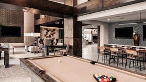 A modern lounge area with a pool table, seating, and a bar. - Landing | Beautiful 2BD, Clubhouse, Rooftop Lounge (San Antonio)