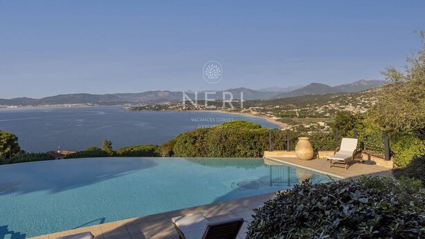 A private pool with a view of the sea and mountains.