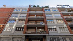 A multi-story residential building with balconies, a gated entrance, and a visible car parked in front. - The Billiards Flat by Wonderful Italy (Turin)