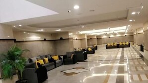 A spacious lobby with a long reception desk, multiple seating areas with cushions, and a polished floor. - Mira Al Rawda Hotel Makkah (Makkah)