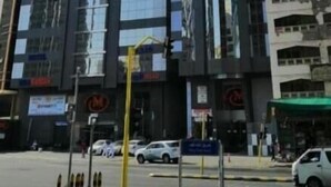 A modern high-rise building with reflective glass windows, multiple floors, and a prominent logo on the facade. - Mira Al Rawda Hotel Makkah (Makkah)