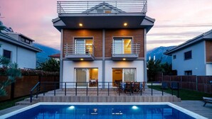 A two-story house with a balcony, a swimming pool, and a mountain view. - Villa Riva - Three Bedroom Villa, Sleeps 6 (Oludeniz)