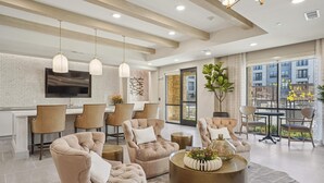 A modern living room with a sofa set, a coffee table, and a dining area with chairs and a table. - Landing | Spectacular 1BD, Yoga Studio, Pool (Anna)