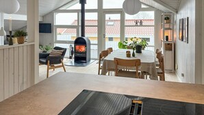 Um quarto acolhedor com lareira, uma mesa de jantar e cadeiras.