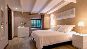 A bedroom with a bed, bedside tables, a nightstand, a window with curtains, a radiator, and a wall-mounted artwork. - Pet friendly home in Genestelle (Genestelle)