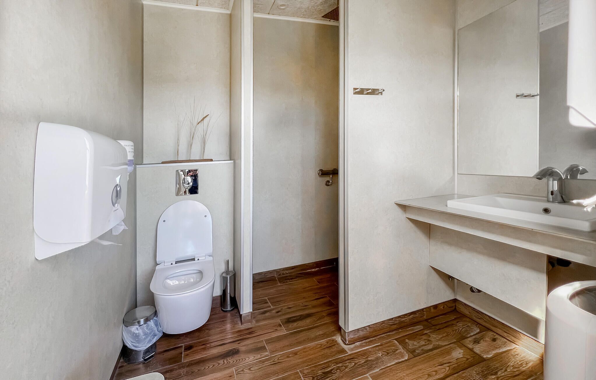 A modern bathroom with a toilet, bidet, and sink.