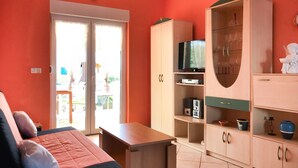 A room with a bed, a TV, and a cabinet with glass doors. - 2 bedroom nice apartment in Vir (Vir)