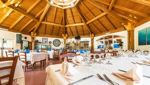 A spacious dining area with high wooden ceilings and multiple tables set for a meal. - Cozy home in Tarquinia with swimming pool (Tarquinia)