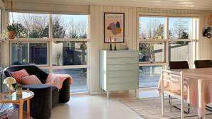 A room with a large window, a chair, a table, and a cabinet. - Lovely home in Fjerritslev with WiFi (Fjerritslev)