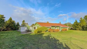 A single-story house with a red roof, a garage, and a well-maintained lawn. - 3 bedroom awesome home in Tarm (Tarm)