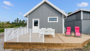 A modern building with a grey exterior and a wooden deck. - Awesome home in Mariestad with WiFi (Mariestad)