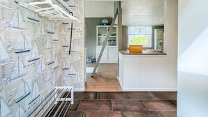 A kitchen with a wooden floor, white cabinets, and a window with a view of greenery. - Awesome home in Mariestad with WiFi (Mariestad)
