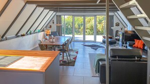 A modern loft with a dining area, a living space, and a view of the outdoors. - 2 bedroom nice home in Humble (Humble)
