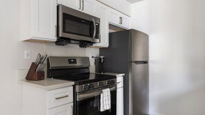 Fridge, dining tables - Landing | Stylish 1BD, Gym (Dunedin)