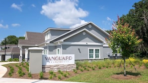 A residential building with a sign reading "Vanguard Apartments". - Landing | Modern 3BD, Gym, Pool (Newberry)