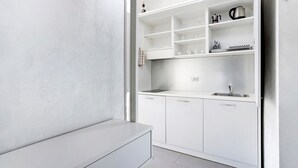 A modern kitchen with white cabinetry, a stainless steel sink, and a countertop. - Apartment 'Smart Central 5' with Balcony, Wi-Fi and Air Conditioning (Milan)