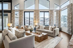 Main living room with wood burning fireplace, wet bar and mountain views