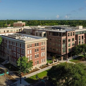 Um edifício em estilo de campus, com telhado plano, várias janelas e fachada de tijolos.