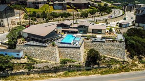 Un quartier résidentiel doté d’une piscine, de murs en pierre et de maisons.