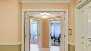 A hallway with a tiled floor, white doors, and a ceiling light fixture. - 30th Floor Strip Views MGM Signature (Las Vegas)