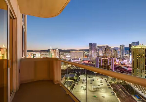 A balcony with a city view at dusk. - 30th Floor Strip Views MGM Signature (Las Vegas)