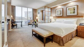 A hotel room with a large bed, a desk, a chair, and a bench. - 30th Floor Strip Views MGM Signature (Las Vegas)