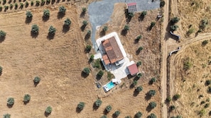An aerial view of a property with a large building, a swimming pool, and a paved area with trees. - Monte Barriga: Cozy Retreat with Private Pool and Air Conditioning (Beja)