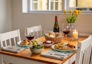 The dining table set for two by the window.
