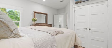Comfortable Queen Bedroom featuring a flat-screen TV, ample closet space