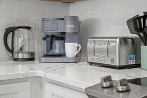 Bright kitchen counter showcasing the Keurig Duo (single serve and carafe) and other necessary breakfast appliances. - Towne Treasures A ~ Brand-New Luxe Coastal Retreat with Private Cocktail Pool (Panama City Beach)