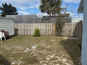 Fully Fenced Privacy: Enjoy your own private outdoor space surrounded by a tall wooden fence, offering great privacy for relaxation and play. - Beach Ya To It! Private Pool, Hot Tub, + Game Room! (Panama City Beach)