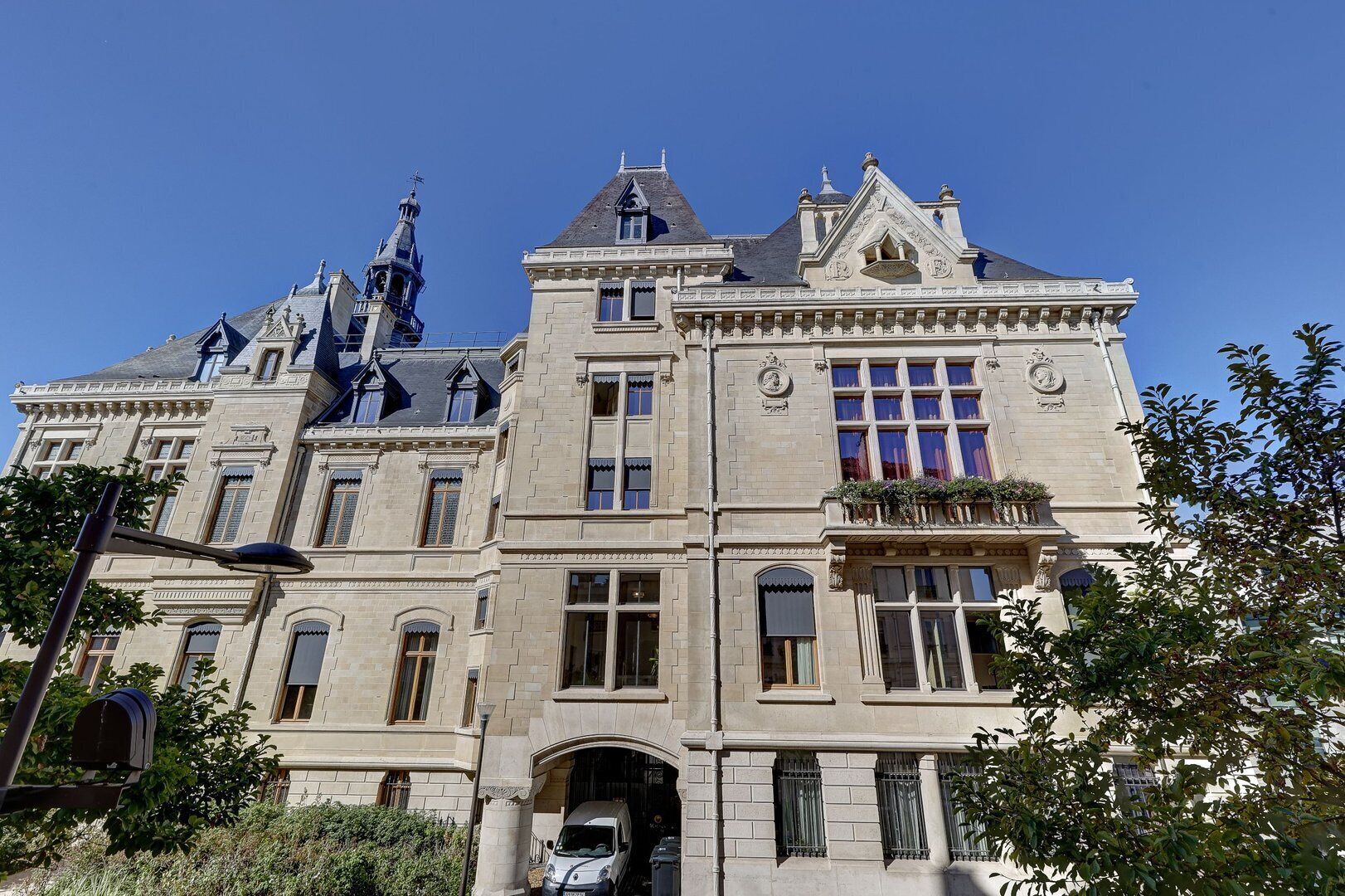 A large, historic building with multiple stories, ornate architectural details, and a prominent entrance.
