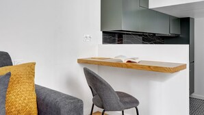 A modern kitchen with a wooden countertop, a chair, and a book on the counter. - TBS 342 - Superb apartment in the heart of Paris 2 (Paris)