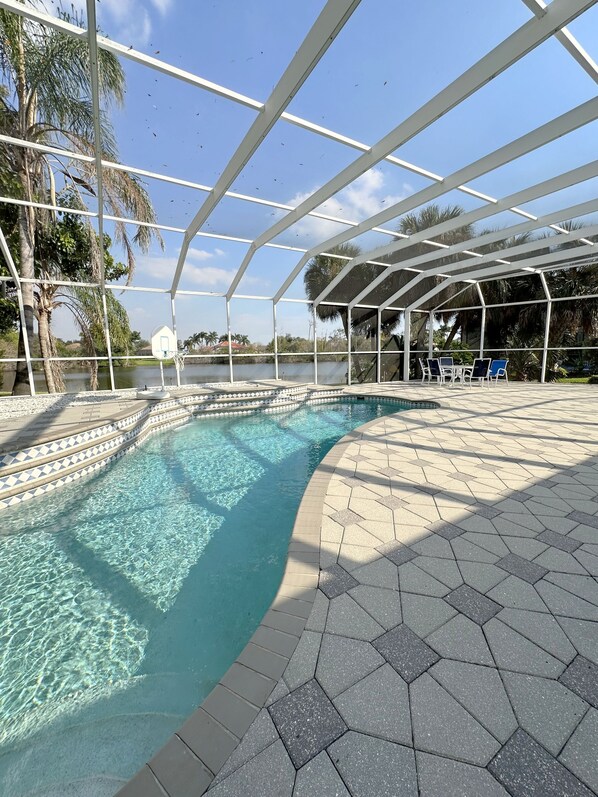 Outdoor pool, a heated pool - Elegant Port Charlotte Oasis: 3BR/3BA Home with Private Heated Pool & Pond View (Port Charlotte)
